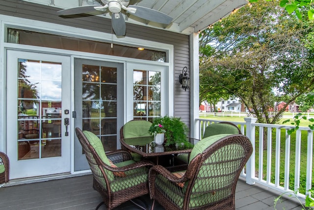 wooden deck featuring a ceiling fan