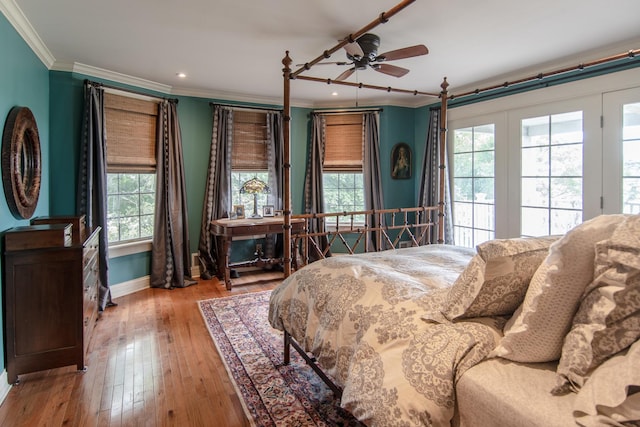 bedroom with recessed lighting, crown molding, wood-type flooring, and baseboards