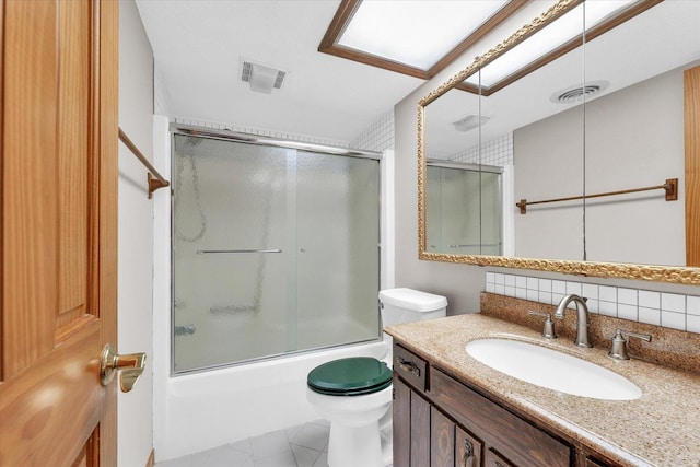full bathroom featuring toilet, backsplash, combined bath / shower with glass door, and vanity