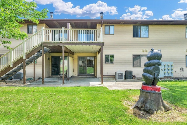 back of house featuring a lawn, central AC, a patio area, and stairway