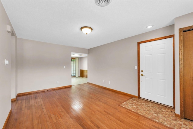 entrance foyer featuring light wood-style floors and baseboards