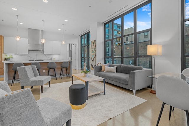 living area with a wall of windows and recessed lighting