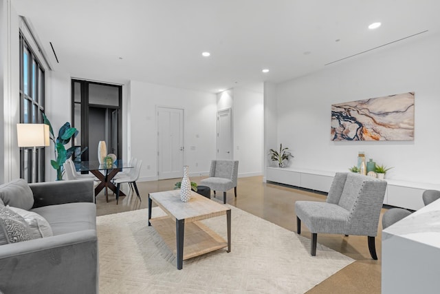 living area with recessed lighting and concrete flooring