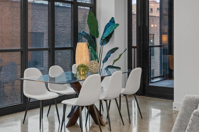 dining room with a wealth of natural light and finished concrete floors
