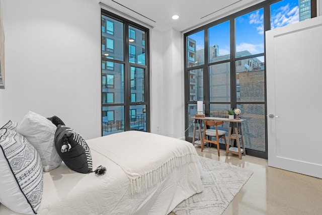 bedroom featuring expansive windows and recessed lighting