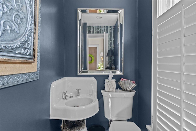half bathroom featuring a sink and toilet