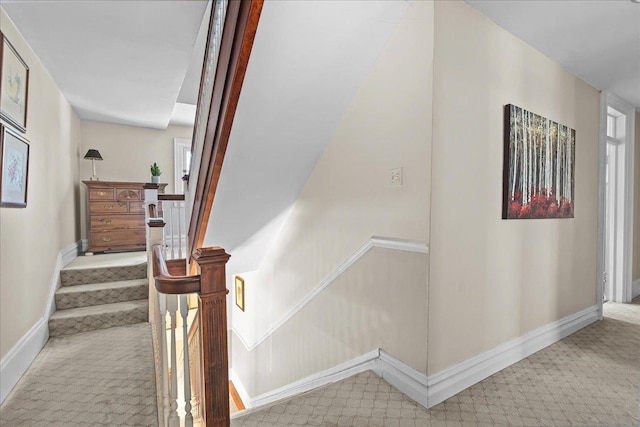 stairs with baseboards and carpet floors