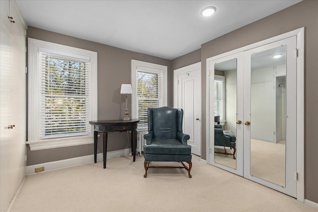 sitting room featuring carpet, baseboards, and french doors