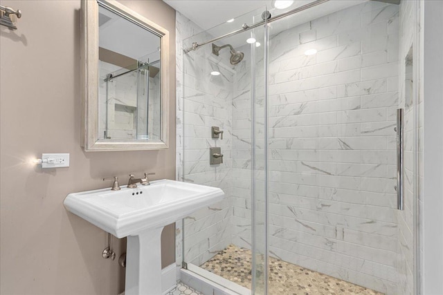 full bath featuring a sink and a shower stall