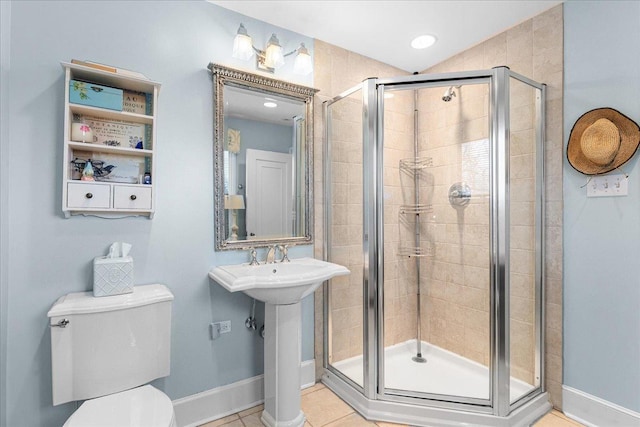 full bathroom with tile patterned flooring, toilet, a sink, baseboards, and a stall shower