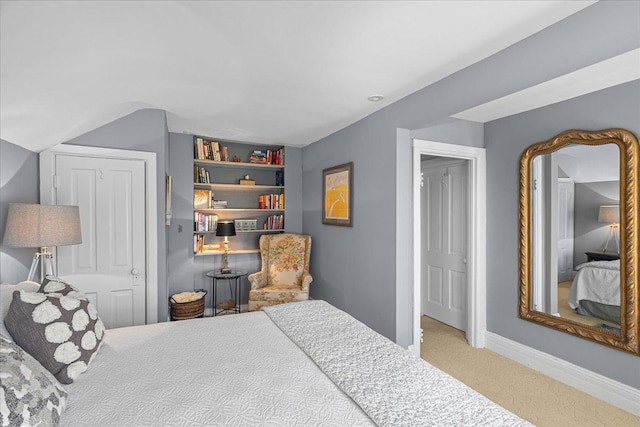 bedroom with baseboards and carpet