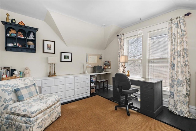 office space featuring vaulted ceiling, carpet flooring, and baseboards