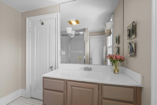bathroom with baseboards, tile patterned flooring, vanity, and a shower with door