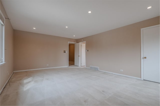 unfurnished room with light colored carpet, baseboards, visible vents, and recessed lighting