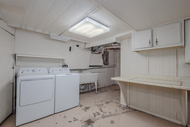 laundry room with separate washer and dryer, electric panel, a sink, and cabinet space