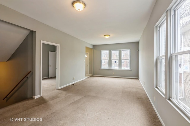 carpeted empty room with baseboards