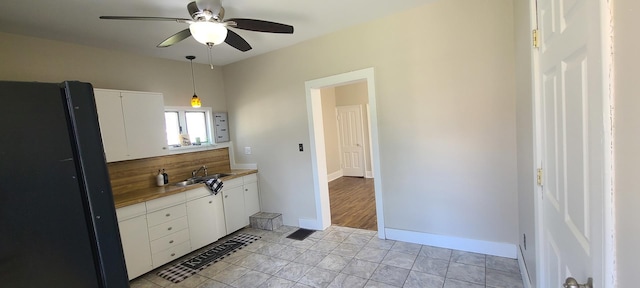bathroom with a sink, ceiling fan, and baseboards