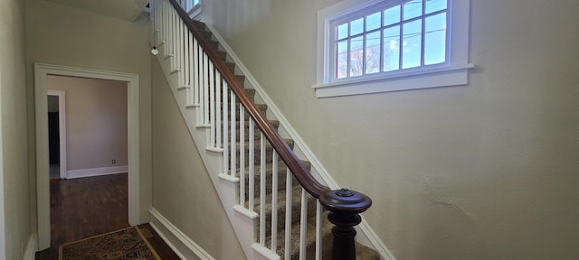 stairs with baseboards and wood finished floors