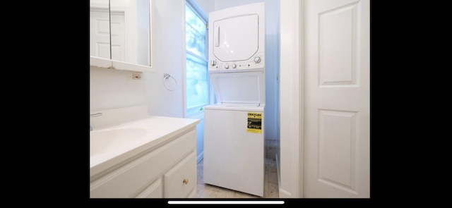 bathroom with vanity and stacked washer and clothes dryer