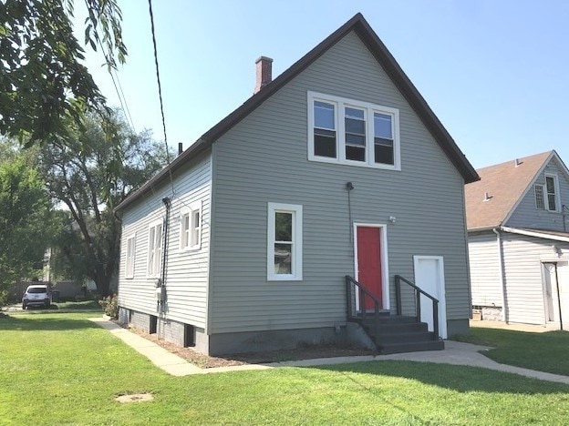 1639 Victoria Ave, North Chicago, IL 60064 - back of property featuring entry steps, a yard, and a chimney