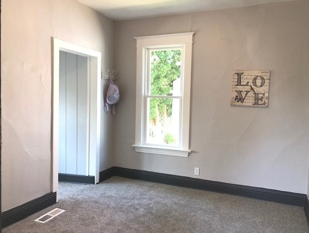 1639 Victoria Ave, North Chicago, IL 60064 - spare room featuring visible vents, baseboards, and carpet floors