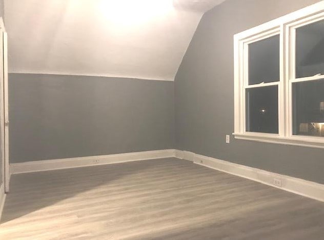 1639 Victoria Ave, North Chicago, IL 60064 - additional living space featuring wood finished floors, baseboards, and vaulted ceiling
