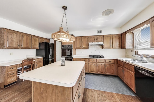 kitchen with ventilation hood, a sink, dark wood finished floors, visible vents, and black appliances