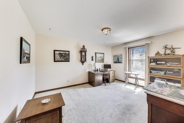 office featuring baseboards and light colored carpet