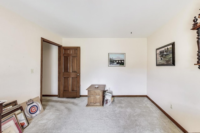 interior space with baseboards and carpet
