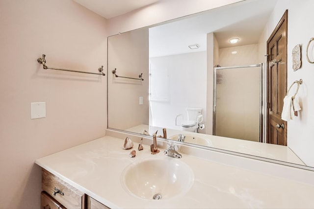 full bathroom with vanity, toilet, and a stall shower
