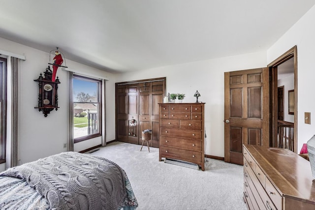 bedroom featuring baseboards and light carpet