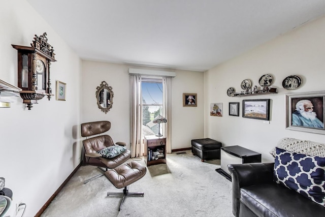 sitting room featuring carpet floors and baseboards