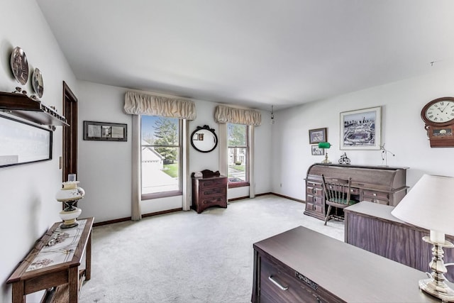 bedroom featuring baseboards and light carpet
