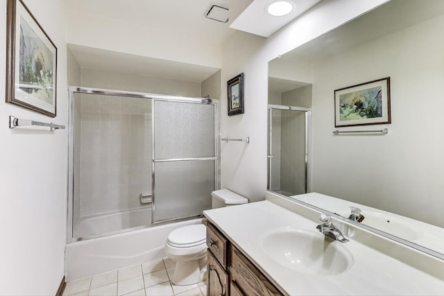 full bath with vanity, bath / shower combo with glass door, tile patterned floors, and toilet