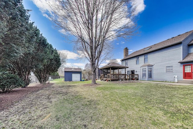 view of yard featuring a gazebo, fence, and a wooden deck