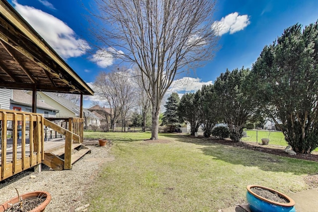 view of yard featuring fence and a wooden deck