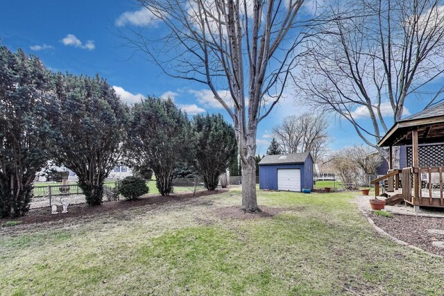 view of yard with a detached garage, a gazebo, an outdoor structure, and a fenced backyard