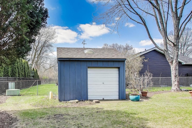 detached garage featuring fence