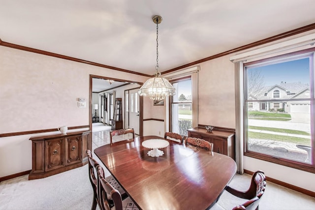 dining room featuring baseboards, ornamental molding, light colored carpet, and a notable chandelier