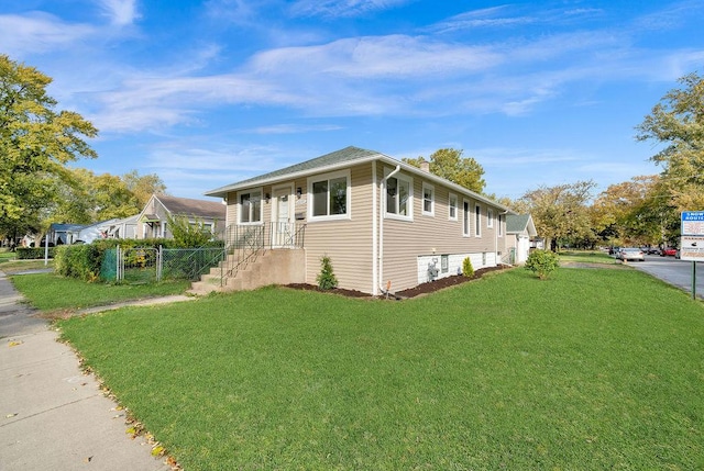 view of property exterior with a yard and fence