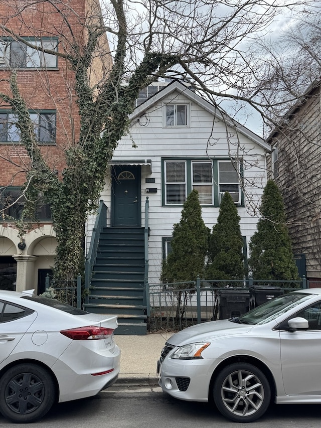 view of front of property featuring fence