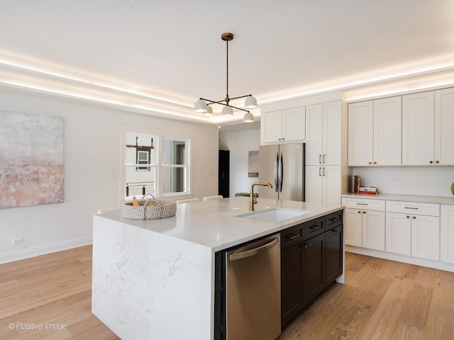 2206 W 107th Pl, Chicago, IL 60643 - kitchen with appliances with stainless steel finishes, a sink, light wood finished floors, a chandelier, and decorative light fixtures