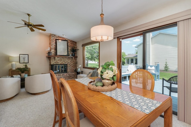 608 Cheshire Dr, Bloomington, IL 61704 - dining space featuring light colored carpet, vaulted ceiling, a fireplace, and ceiling fan