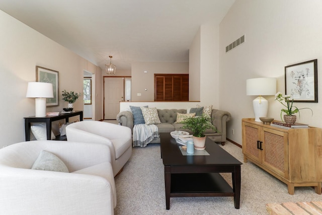 608 Cheshire Dr, Bloomington, IL 61704 - living area featuring a chandelier, light carpet, and baseboards