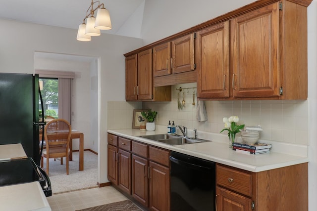 608 Cheshire Dr, Bloomington, IL 61704 - kitchen with black appliances, a sink, brown cabinetry, and light countertops