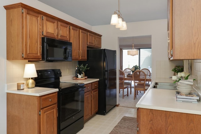 608 Cheshire Dr, Bloomington, IL 61704 - kitchen with black appliances, a sink, light countertops, decorative backsplash, and brown cabinets
