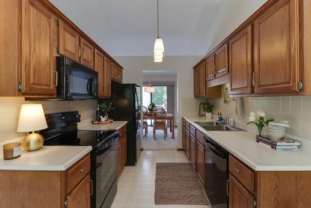 608 Cheshire Dr, Bloomington, IL 61704 - kitchen featuring black appliances, a sink, tasteful backsplash, brown cabinets, and light countertops