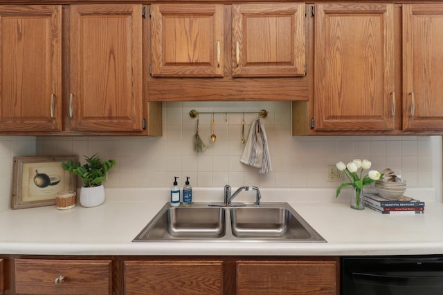 608 Cheshire Dr, Bloomington, IL 61704 - kitchen featuring dishwasher, a sink, light countertops, and decorative backsplash