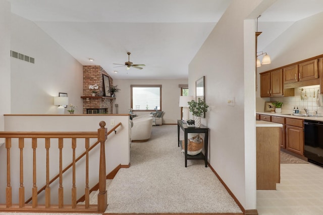 608 Cheshire Dr, Bloomington, IL 61704 - hallway with vaulted ceiling, a sink, light carpet, and baseboards