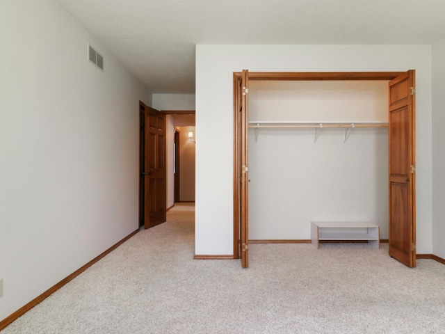 608 Cheshire Dr, Bloomington, IL 61704 - unfurnished bedroom with light colored carpet, a closet, and baseboards